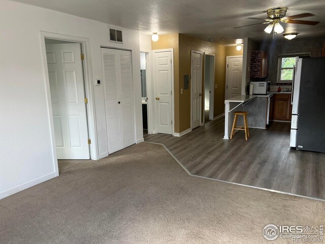 225 E 8th Ave Unit B11, Longmont, CO 80504 - living room with ceiling fan, dark colored carpet, and dark wood finished floors