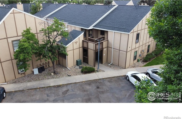 225 E 8th Ave Unit B11, Longmont, CO 80504 - view of front of home with roof with shingles and uncovered parking