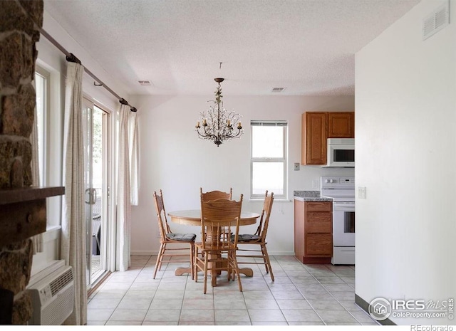 3345 Chisholm Trl Unit 206, Boulder, CO 80301 - dining room with a chandelier, light tile patterned flooring, and a textured ceiling