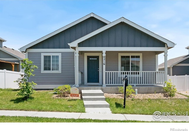 4216 Yellowbells Dr, Evans, CO 80620 - bungalow-style house with covered porch and board and batten siding