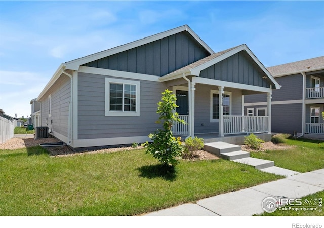 4216 Yellowbells Dr, Evans, CO 80620 - view of front of house with board and batten siding, a porch, and a front yard
