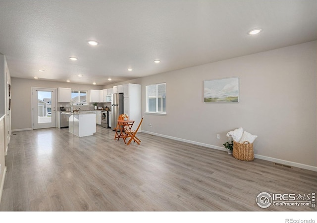 4216 Yellowbells Dr, Evans, CO 80620 - living area with recessed lighting and light wood finished floors
