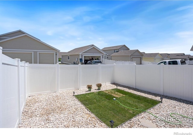 4216 Yellowbells Dr, Evans, CO 80620 - fenced backyard featuring a residential view and a garage