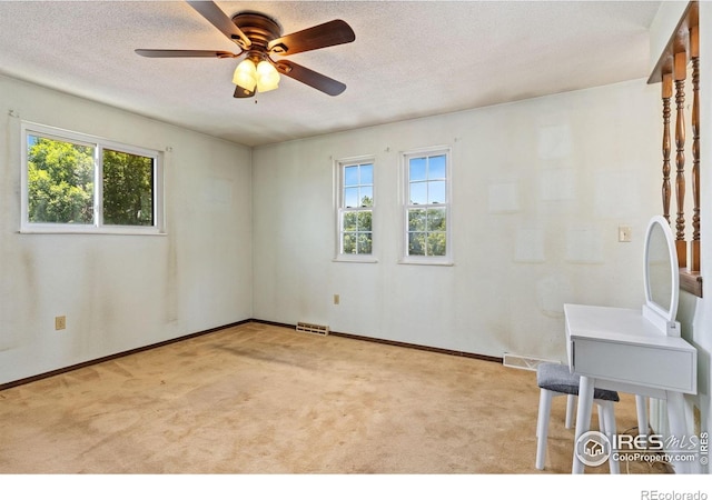 610 S Broadway Ave, Fort Lupton, CO 80621 - spare room with healthy amount of natural light, carpet flooring, a textured ceiling, and a ceiling fan