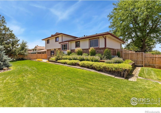610 S Broadway Ave, Fort Lupton, CO 80621 - back of property featuring brick siding and a fenced backyard