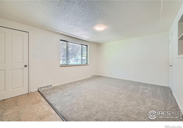 131 E 15th Ave, Longmont, CO 80504 - unfurnished bedroom featuring a textured ceiling and carpet flooring