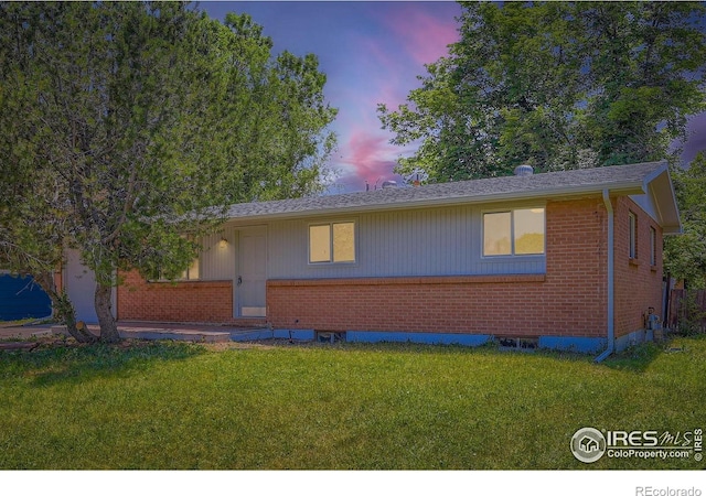 131 E 15th Ave, Longmont, CO 80504 - view of front facade featuring brick siding and a yard
