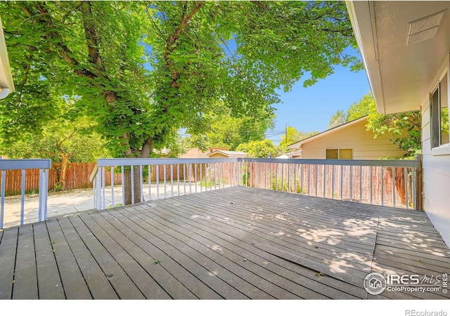 131 E 15th Ave, Longmont, CO 80504 - wooden terrace featuring a fenced backyard and a patio area