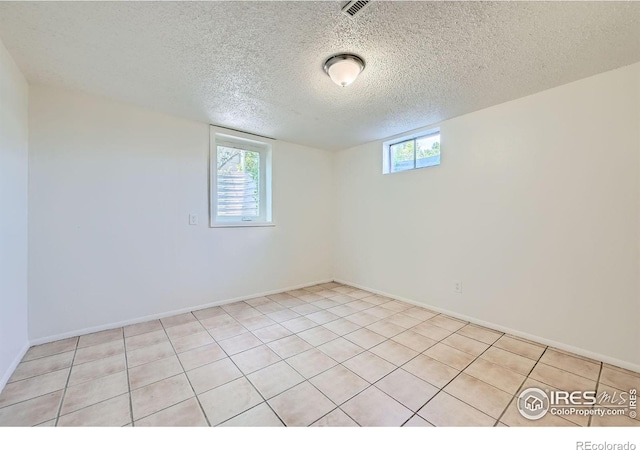 131 E 15th Ave, Longmont, CO 80504 - empty room featuring plenty of natural light, a textured ceiling, and light tile patterned floors