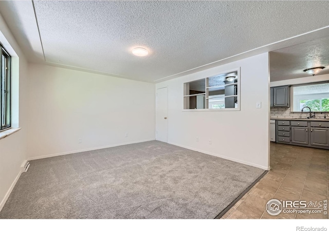 131 E 15th Ave, Longmont, CO 80504 - spare room with a textured ceiling and carpet floors