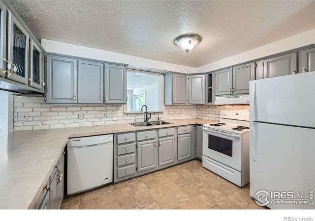 131 E 15th Ave, Longmont, CO 80504 - kitchen with white appliances, gray cabinets, decorative backsplash, light countertops, and under cabinet range hood