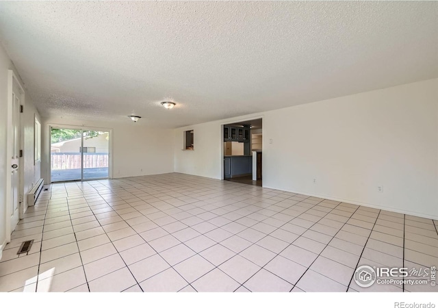 131 E 15th Ave, Longmont, CO 80504 - spare room with a textured ceiling, a baseboard radiator, and light tile patterned floors
