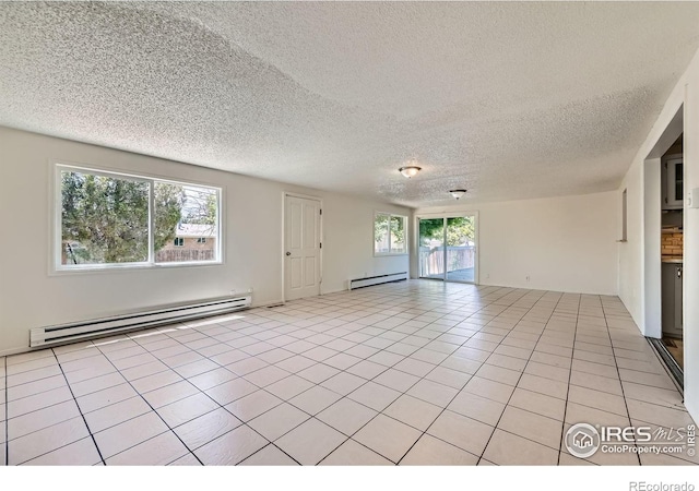 131 E 15th Ave, Longmont, CO 80504 - spare room with a baseboard heating unit, baseboard heating, a textured ceiling, and light tile patterned floors