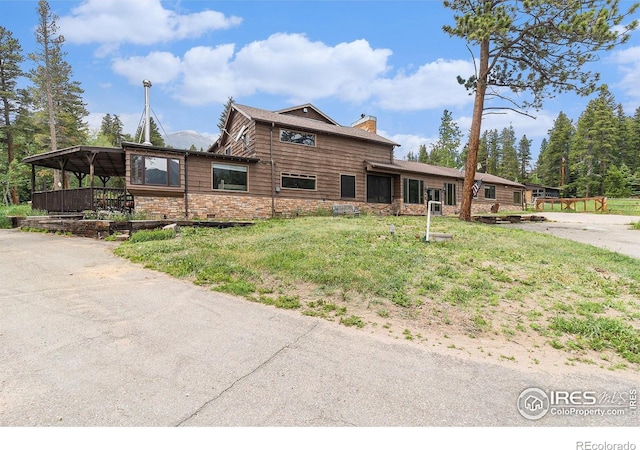 8451 Peak To Peak Hwy, Allenspark, CO 80510 - view of front of home with a chimney, a front lawn, and stone siding