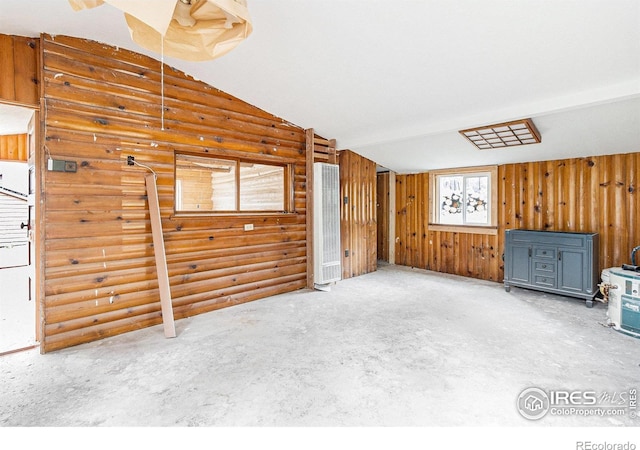 8451 Peak To Peak Hwy, Allenspark, CO 80510 - unfurnished living room featuring a heating unit, lofted ceiling, and rustic walls