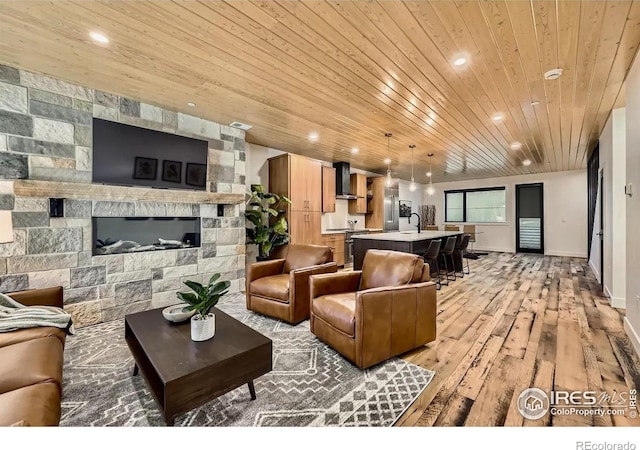 1109 Neon Forest Cir # 2, Longmont, CO 80504 - living room with wooden ceiling, light wood-style flooring, recessed lighting, and a stone fireplace
