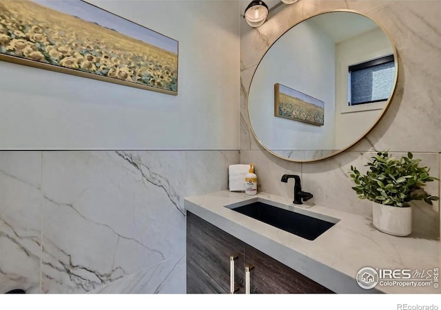 1109 Neon Forest Cir # 2, Longmont, CO 80504 - bathroom featuring tile walls, vanity, and backsplash
