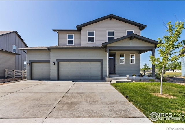 3775 Ginkgo St, Wellington, CO 80549 - view of front of property featuring driveway, an attached garage, and a porch