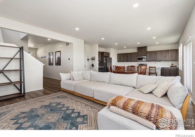 3775 Ginkgo St, Wellington, CO 80549 - living area with dark wood-style floors, recessed lighting, and stairway