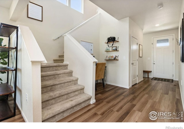 3775 Ginkgo St, Wellington, CO 80549 - foyer entrance featuring wood finished floors and stairway