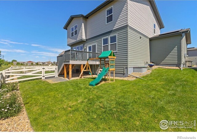 3775 Ginkgo St, Wellington, CO 80549 - rear view of house with a wooden deck and a playground