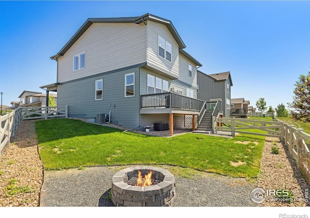 3775 Ginkgo St, Wellington, CO 80549 - rear view of house featuring an outdoor fire pit, a fenced backyard, a deck, and stairway