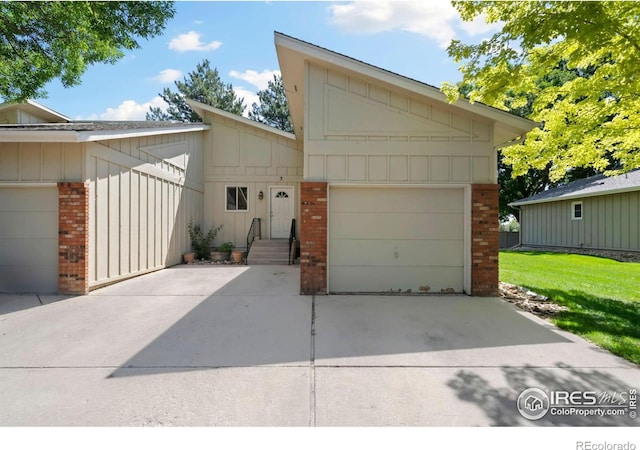 3012 Anchor Way Unit 3, Fort Collins, CO 80525 - view of front of home featuring brick siding, driveway, board and batten siding, and a garage