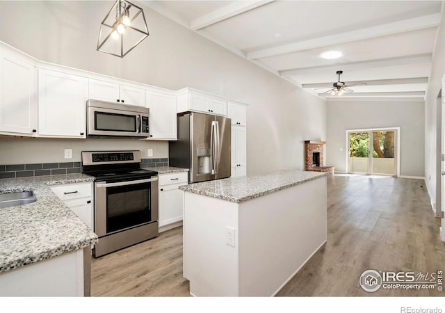 3012 Anchor Way Unit 3, Fort Collins, CO 80525 - kitchen with appliances with stainless steel finishes, ceiling fan, light wood-type flooring, beamed ceiling, and a center island