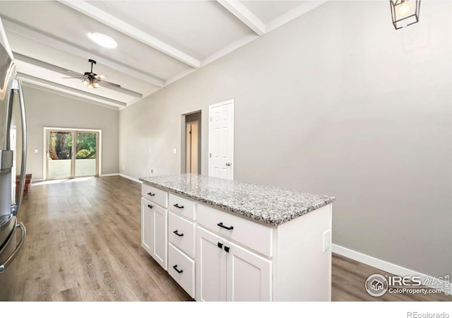 3012 Anchor Way Unit 3, Fort Collins, CO 80525 - kitchen with a ceiling fan, freestanding refrigerator, white cabinetry, a center island, and light wood-style floors