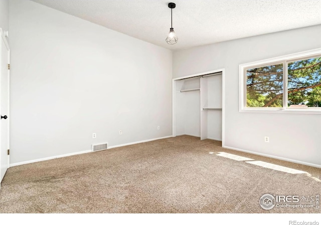 3012 Anchor Way Unit 3, Fort Collins, CO 80525 - unfurnished bedroom with carpet flooring, a closet, and a textured ceiling
