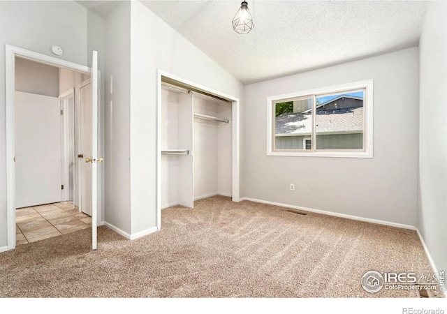 3012 Anchor Way Unit 3, Fort Collins, CO 80525 - unfurnished bedroom with carpet floors, a closet, and a textured ceiling