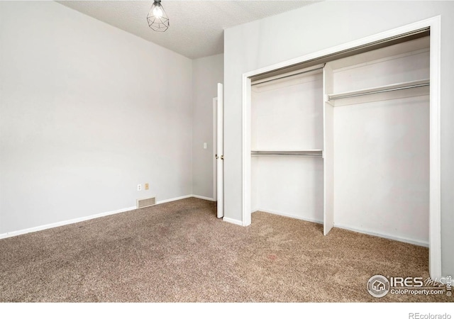 3012 Anchor Way Unit 3, Fort Collins, CO 80525 - unfurnished bedroom featuring carpet floors, a closet, and a textured ceiling