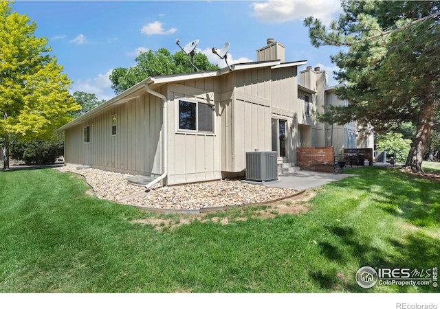 3012 Anchor Way Unit 3, Fort Collins, CO 80525 - back of property with a yard, board and batten siding, a chimney, and a patio