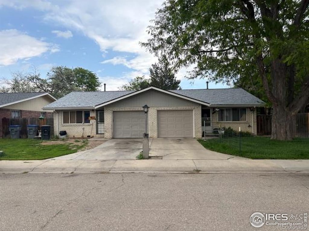 1906 Yeager Dr, Longmont, CO 80501 - ranch-style home with a garage, driveway, and brick siding