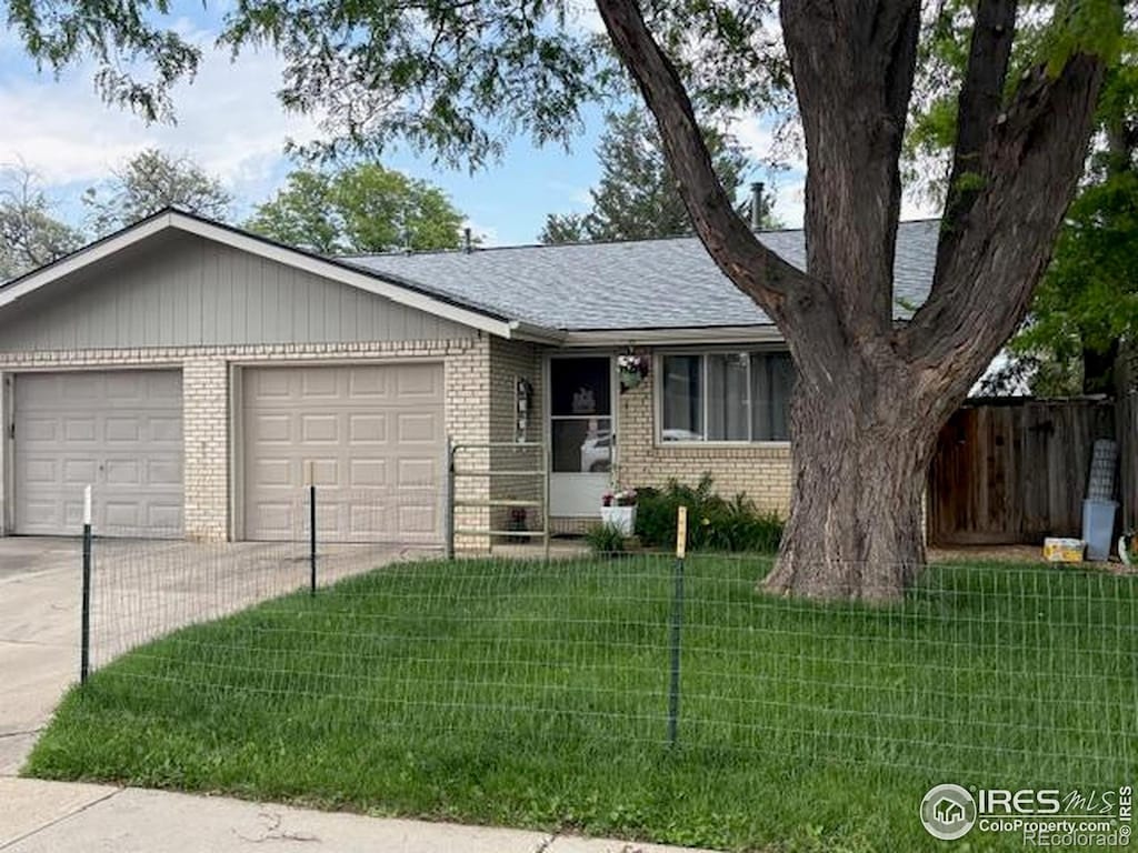1906 Yeager Dr, Longmont, CO 80501 - ranch-style home featuring brick siding, driveway, a garage, and roof with shingles