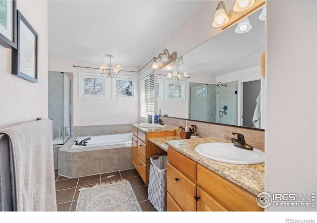 8356 Louden Circle Ft, Collins, CO 80528 - full bathroom featuring a chandelier, tile patterned flooring, a stall shower, two vanities, and a garden tub