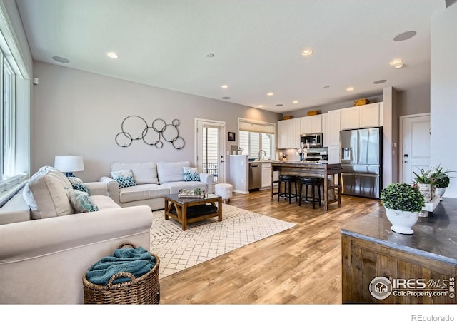 1419 W 67th Ave, Denver, CO 80221 - living area featuring light wood-style flooring and recessed lighting