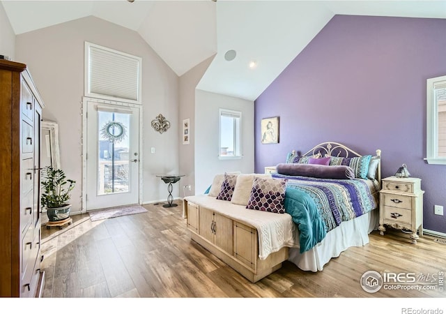 1419 W 67th Ave, Denver, CO 80221 - bedroom featuring high vaulted ceiling, wood finished floors, and access to outside