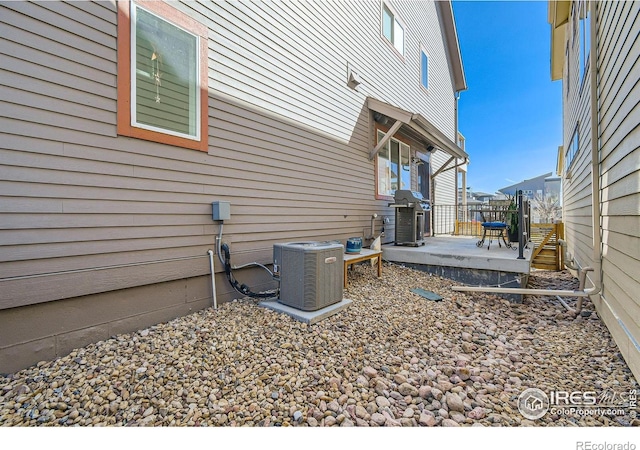 1419 W 67th Ave, Denver, CO 80221 - view of side of property featuring a central AC unit and a wooden deck