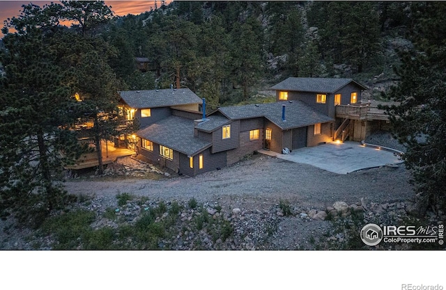 95 Forgotten Way, Estes Park, CO 80517 - view of front of property with gravel driveway and a wooden deck