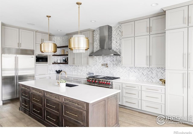 15373 Irving Ct, Broomfield, CO 80023 - kitchen with high end appliances, wall chimney range hood, light countertops, and tasteful backsplash