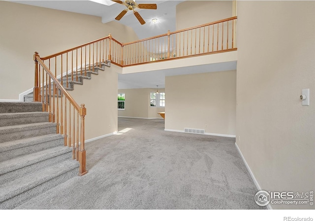3132 Concord Way, Longmont, CO 80503 - stairway with ceiling fan, carpet floors, and high vaulted ceiling