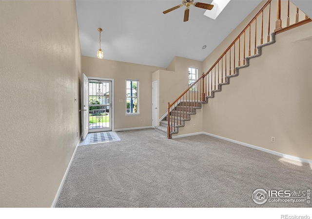 3132 Concord Way, Longmont, CO 80503 - entryway featuring stairs, carpet flooring, a ceiling fan, a textured wall, and high vaulted ceiling