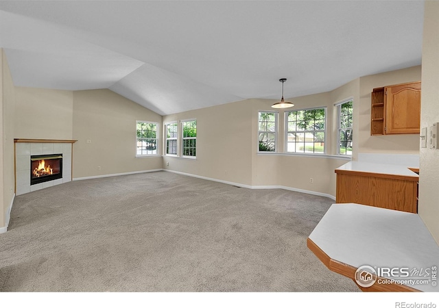 3132 Concord Way, Longmont, CO 80503 - unfurnished living room with carpet, a tile fireplace, and vaulted ceiling