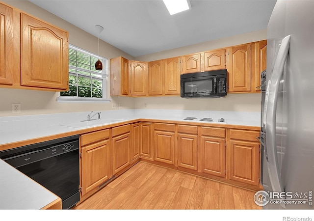 3132 Concord Way, Longmont, CO 80503 - kitchen with black appliances, light wood-style flooring, decorative light fixtures, and light countertops