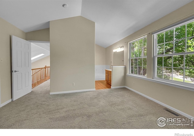 3132 Concord Way, Longmont, CO 80503 - empty room featuring light carpet, lofted ceiling, and a smoke detector