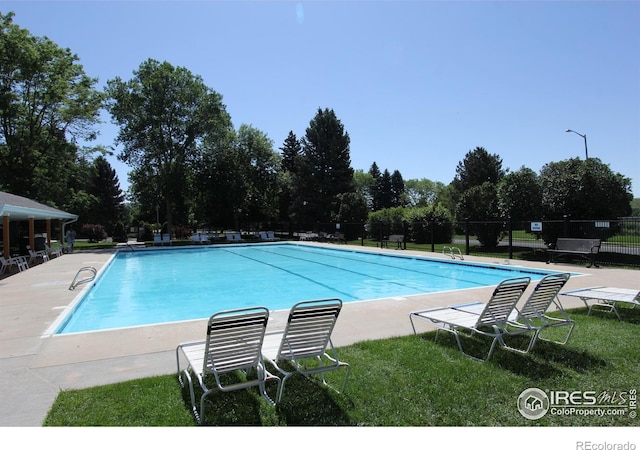 3132 Concord Way, Longmont, CO 80503 - community pool featuring view of wooded area and a patio area
