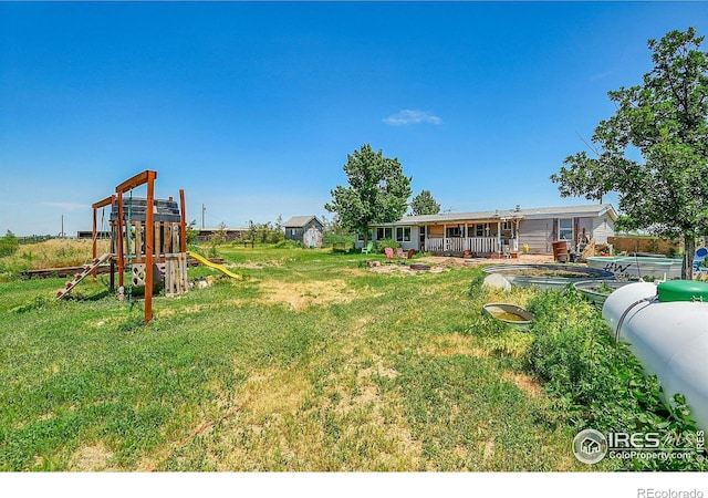 18247 County Road 22, Fort Lupton, CO 80621 - view of green lawn with a playground