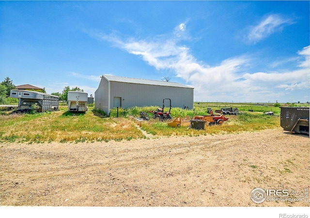 18247 County Road 22, Fort Lupton, CO 80621 - view of side of home with a pole building, an outdoor structure, and a metal roof