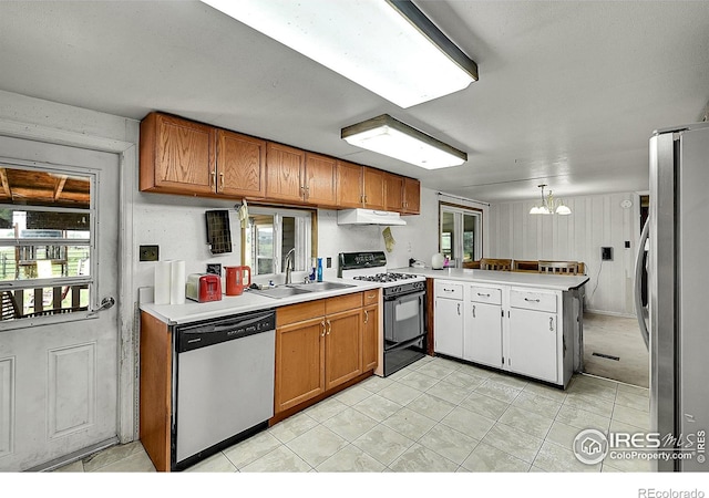 18247 County Road 22, Fort Lupton, CO 80621 - kitchen featuring appliances with stainless steel finishes, a peninsula, under cabinet range hood, a chandelier, and light countertops